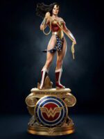 Statue of Wonder Woman holding her lasso, wearing red and gold armor with a star-spangled bikini bottom, atop a decorative gold pedestal with the emblem.