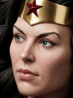 Close-up of a woman's face wearing a gold tiara with a red star, blue eyes looking to the side.