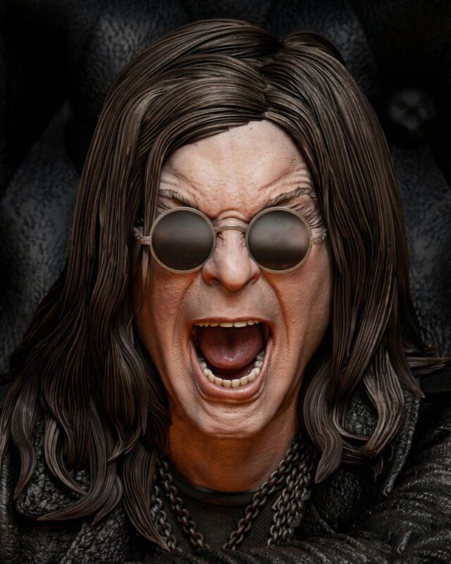 Person with long dark hair and round sunglasses screaming with mouth wide open, wearing a black leather jacket and chain necklace.