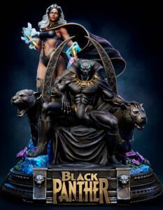Statue of Black Panther seated on a throne, flanked by two panther sculptures, with a female sorceress standing behind and a 'Black Panther' plaque below.