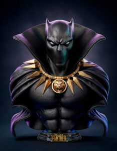 Bust of Black Panther wearing a high-collared cape and a gold spiked necklace; dramatic dark background.