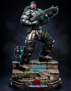Collector statue of Marcus Fenix from Gears of War, in armor and heavy rifle, posed on a rocky pedestal with blue glow accents and the Gears of War logo nearby.