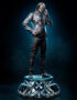 Life-size statue of a woman in a metallic jacket and sunglasses standing on an X-Men themed pedestal base.